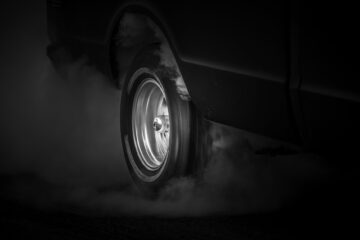 grayscale photo of spinning tire