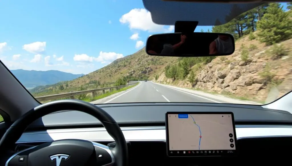 Tesla vehicle on a scenic road with navigation display visible through windshield
