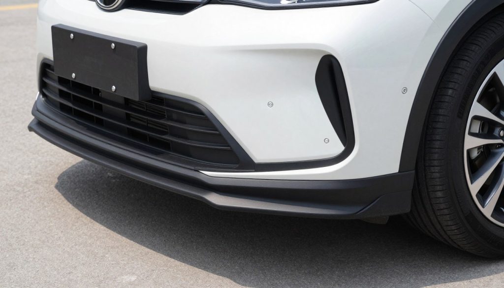 Well-maintained car front end showing intact plastic piece under bumper